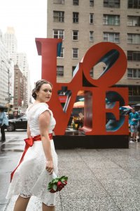 Photo of a bride by Love sign in Manhattan
