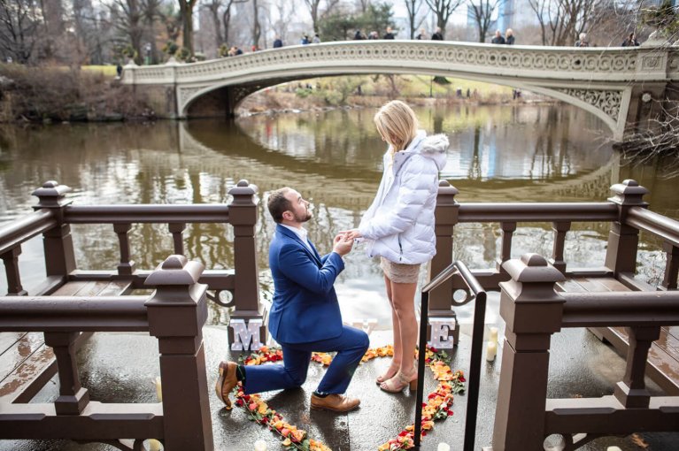 Proposal inside a heart of roses on the dock by Bow Bridge in Central Park