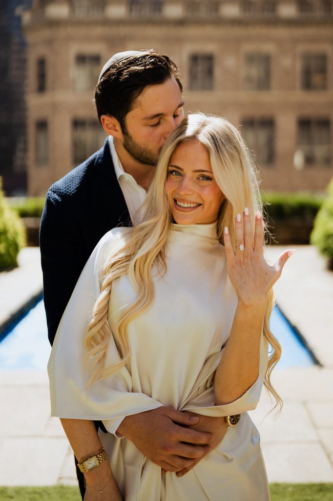Woman showing her engagement ring on the rooftop garden at 620 Loft & Garden, New York