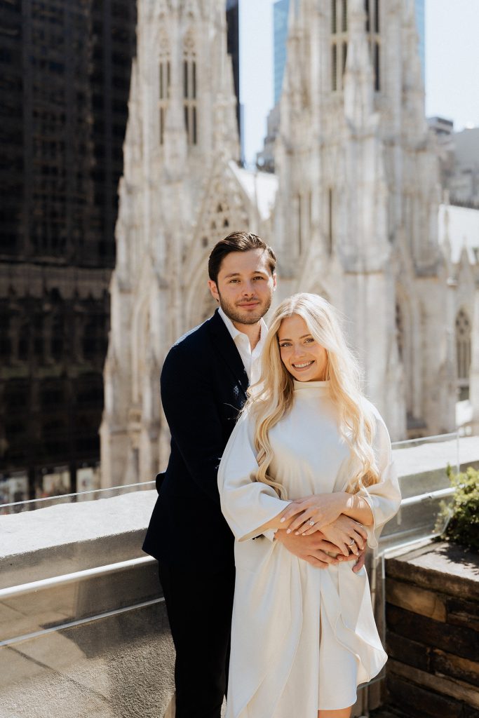 Newly engaged couple at 620 Loft & Garden with the spires of St. Patrick's Cathedral behind them
