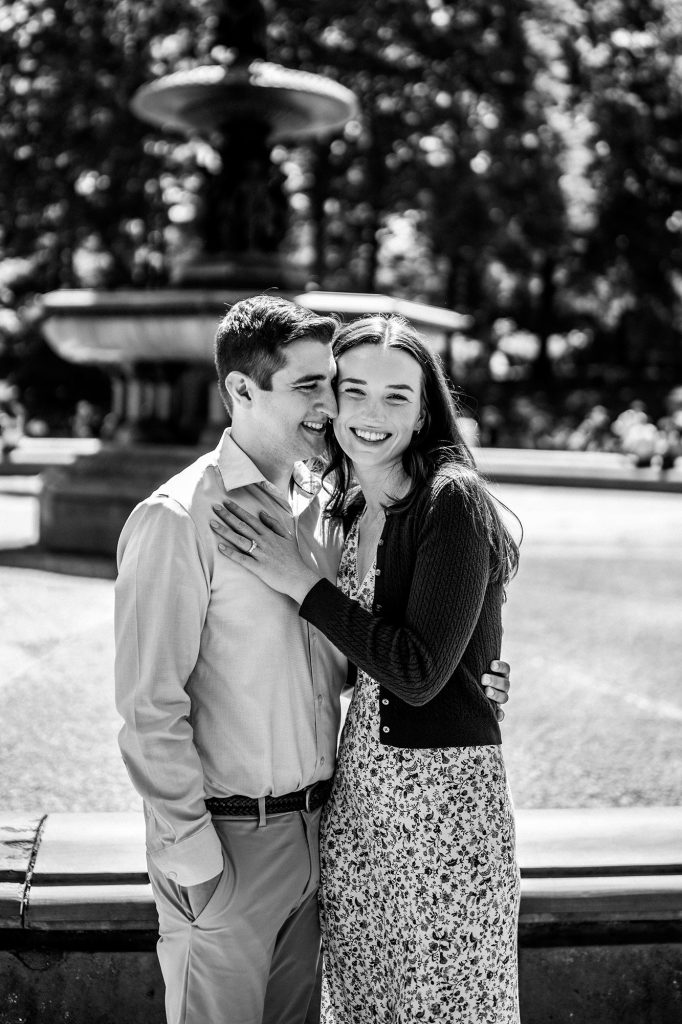 Black and white engagement portrait at Bethesda Fountain in Central Park, New York
