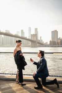 Surprise proposal at Brooklyn Bridge Park in DUMBO with the Manhattan skyline across the East River