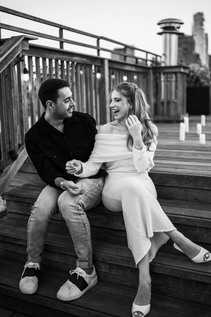 Black and white portrait of a newly engaged couple on a private rooftop in Manhattan