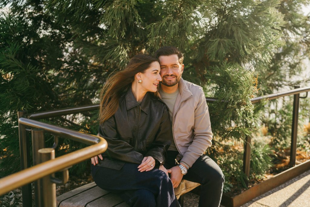 Newly engaged couple sitting together at Little Island in Manhattan after a surprise proposal