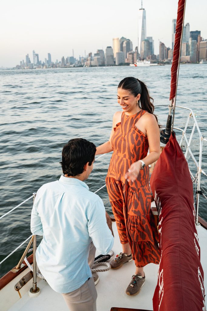 Surprise proposal on a yacht in New York, the Lower Manhattan skyline behind