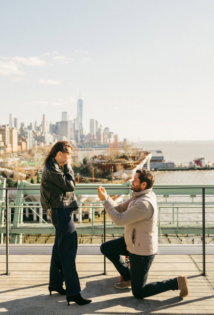 Surprise proposal at Pier 57 in Manhattan with the Downtown skyline across the Hudson River