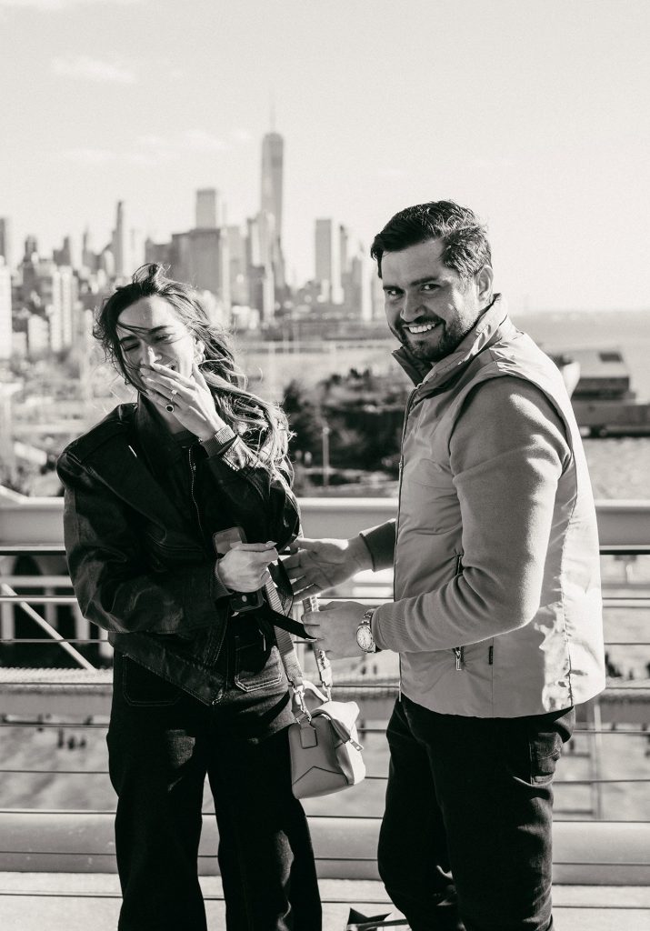 Black and white engagement portrait with flowers at Pier 57 in Manhattan, New York