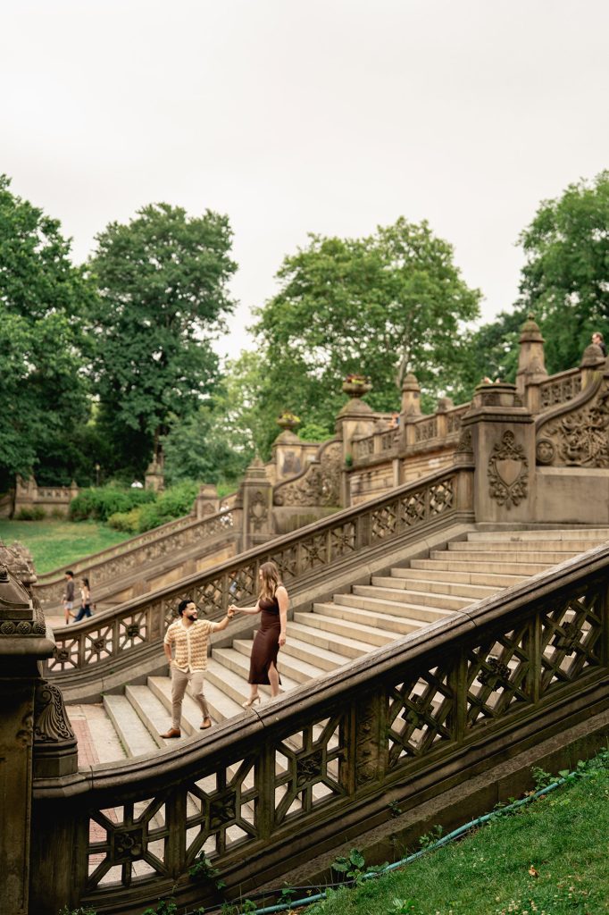 Newly engaged couple on the stairs at Bethesda Terrace in Central Park, New York