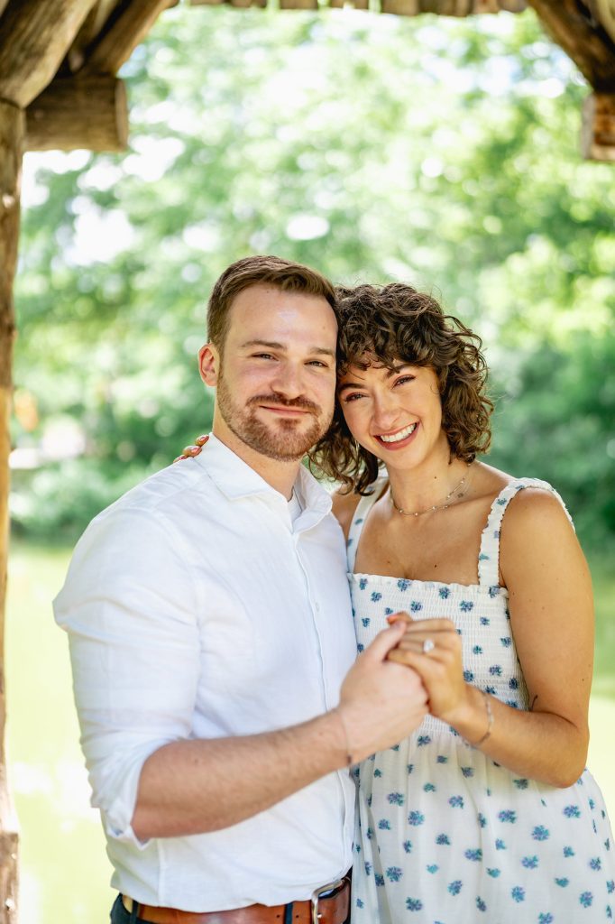 Portrait of a newly engaged couple holding hands in Central Park in summer